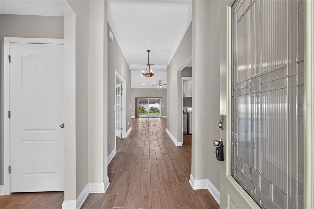 A view from the front entryway looking down a hallway toward a living area — 23 PYRITE PLACE, ST AUGUSTINE, FL