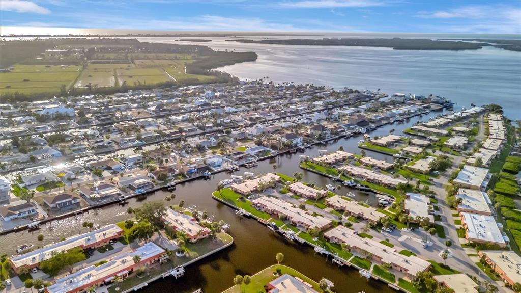 An aerial view of a waterfront residential neighborhood with canals, docks, and boats — 4096 EL DORADO COVE, BRADENTON, FL