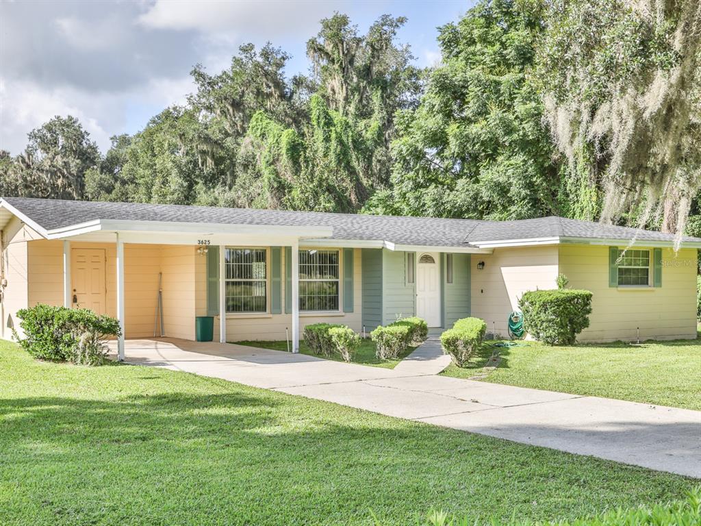 A single-story house with a carport, light-colored siding, and a concrete driveway on a lawn — 3625 E GANDY ROAD, BARTOW, FL