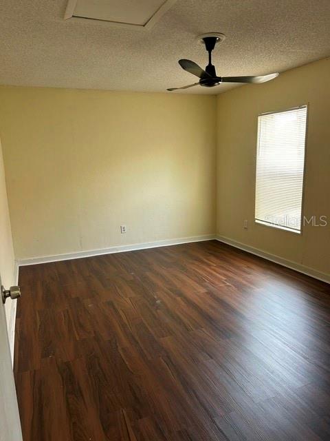 An empty bedroom features wood-look flooring, beige walls, a ceiling fan, and a window — 6224 STANWIN DRIVE, APOPKA, FL