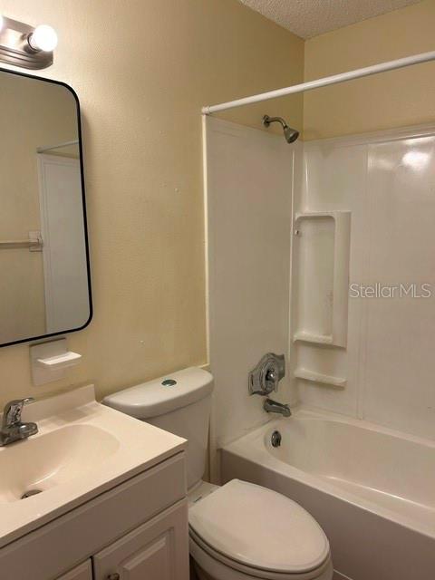 A bathroom features a vanity with a sink, a toilet, and a shower-tub combination — 6224 STANWIN DRIVE, APOPKA, FL