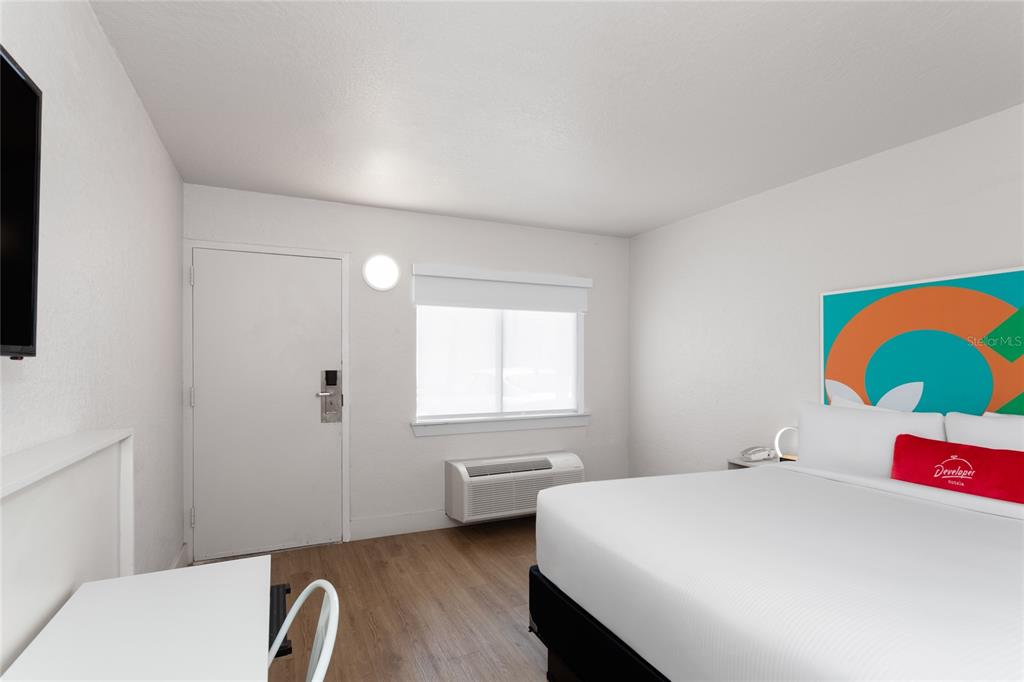 A hotel room features a bed, a desk, a window, and a door — 5367 W IRLO BRONSON MEMORIAL HIGHWAY UNIT 2-219, KISSIMMEE, FL