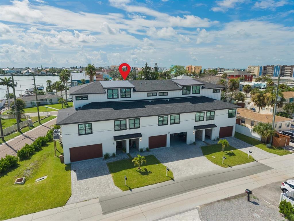 An aerial view of a multi-unit residential building with a dark roof and white siding — 187 145TH AVENUE E UNIT 3, MADEIRA BEACH, FL