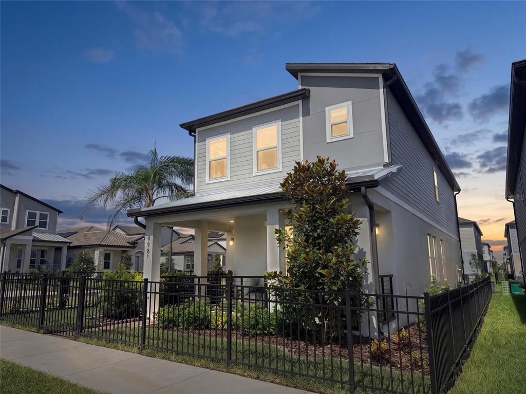 An aerial view shows a two-story suburban house highlighted in a residential neighborhood — 4981 CORAL BEAN ALLEY, WINTER GARDEN, FL