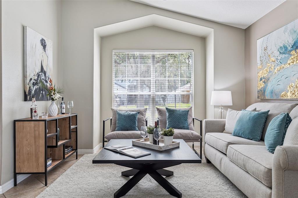 A living room features a beige sofa, two armchairs, a coffee table, and wall art — 1462 BARN OWL LOOP, SANFORD, FL