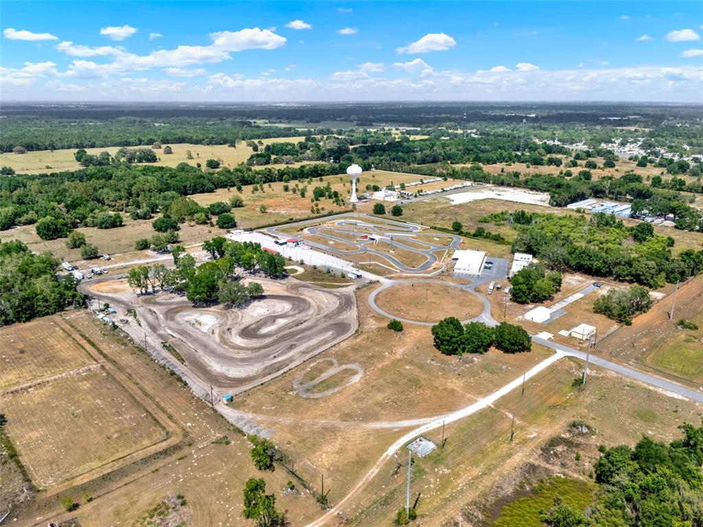 Aerial view of a dirt motocross track and a paved go-kart track — 5765 PIT ROAD, BUSHNELL, FL
