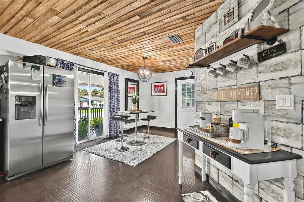A kitchen with a wood-plank ceiling, stainless steel refrigerator, and a coffee station — 702 N CHAPEL STREET, BUNNELL, FL