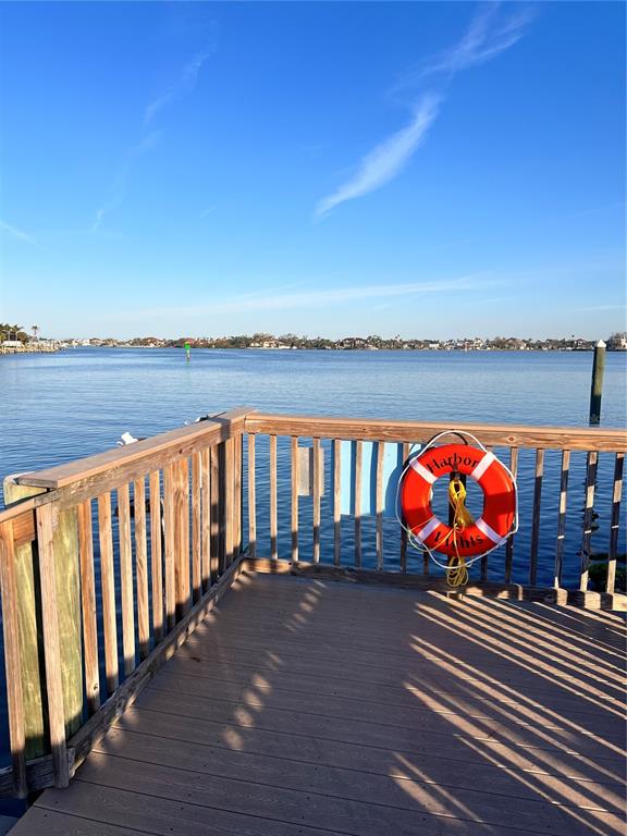 A wooden deck overlooks a calm body of water with a life preserver attached — 102 2ND AVENUE, VENICE, FL