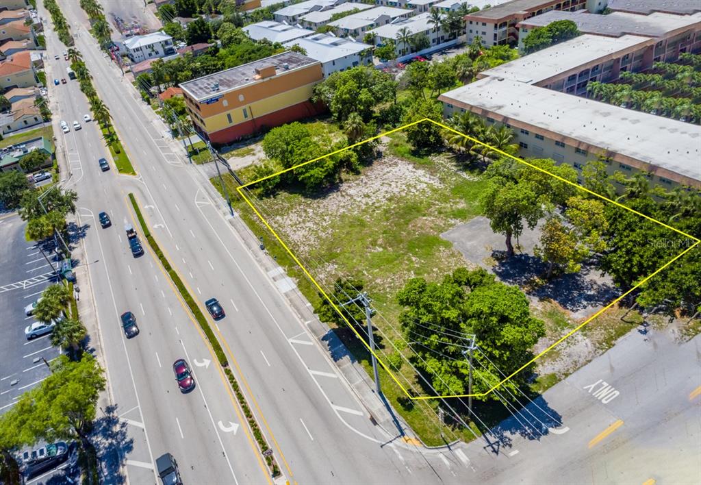 An aerial view shows a vacant, rectangular lot outlined in yellow next to a road — 600 E ATLANTIC BOULEVARD, POMPANO BEACH, FL