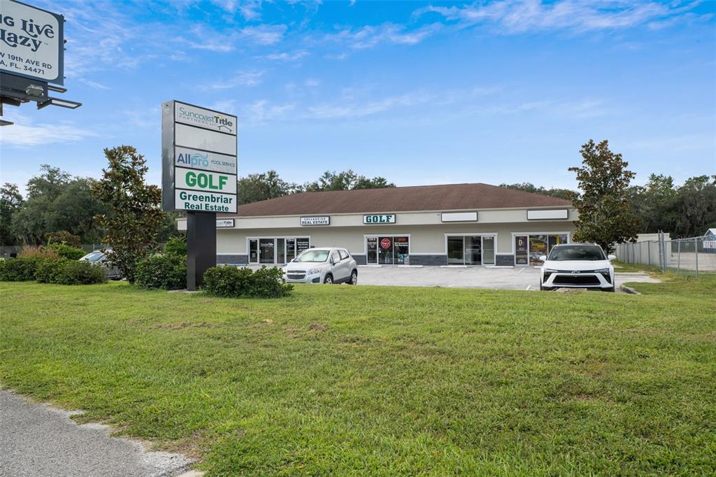 A single-story commercial building with a parking lot and a tall signage pillar — 1298 E NORVELL BRYANT HIGHWAY, HERNANDO, FL