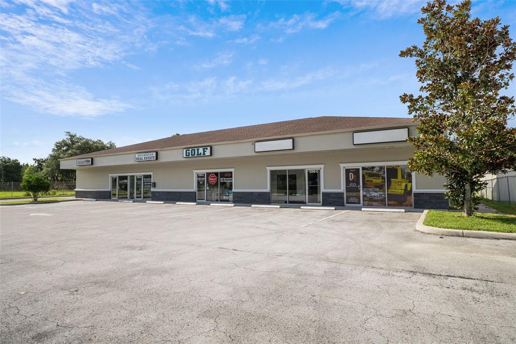 A single-story commercial strip mall building with a parking lot in front — 1298 E NORVELL BRYANT HIGHWAY, HERNANDO, FL