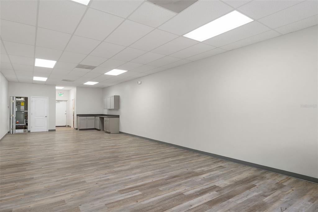 An empty commercial office space with wood-look flooring, white walls, and a drop ceiling — 1298 E NORVELL BRYANT HIGHWAY, HERNANDO, FL