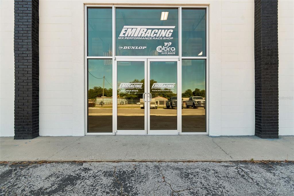 The exterior of a commercial building features a glass double-door entrance with signage — 15552 US 301, DADE CITY, FL