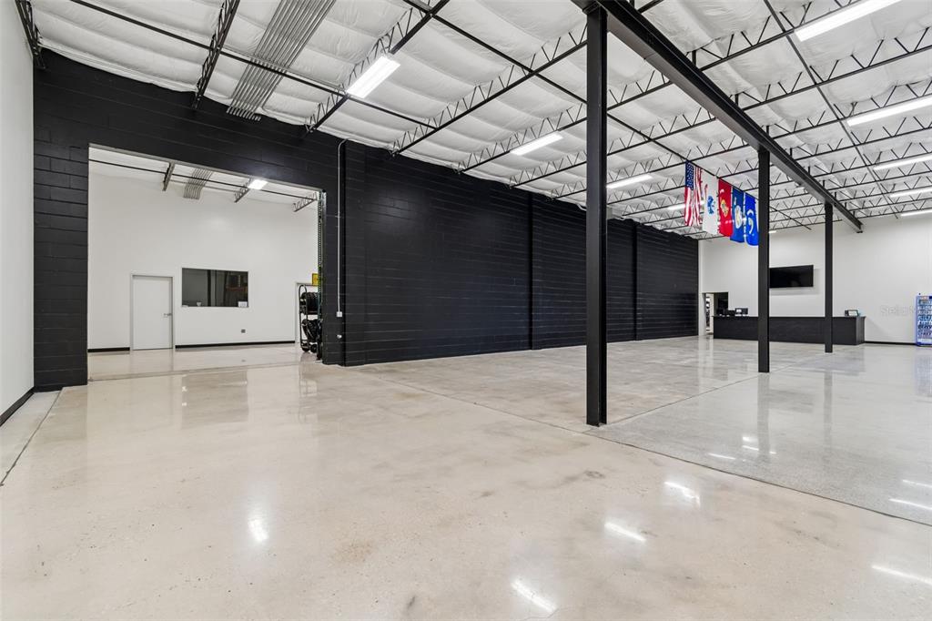 A large, open industrial space features polished concrete floors, black block walls, and exposed ceilings — 15552 US 301, DADE CITY, FL