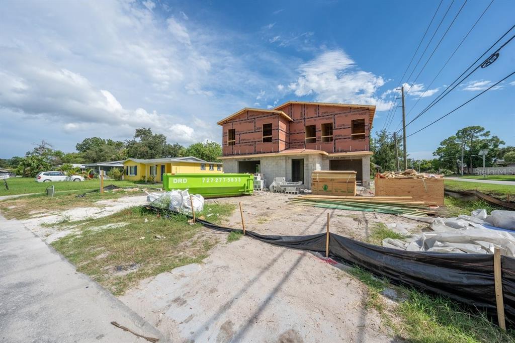 A two-story house under construction with a green dumpster in the front yard — 6760 HIBISCUS AVENUE S, SOUTH PASADENA, FL