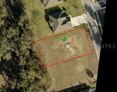 An aerial view shows a vacant rectangular residential lot outlined in red next to a house — 3138 SILVERMINES AVENUE, ORMOND BEACH, FL