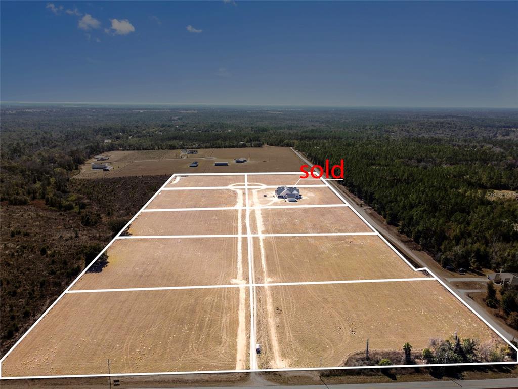 An aerial view shows a large, subdivided plot of land with one house already built — 4138 ROYAL SKY (LOT 10) COURT, BROOKSVILLE, FL