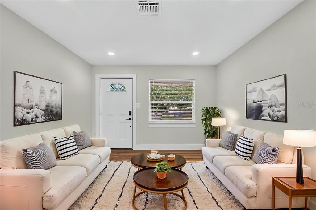 A living room features two white sofas facing each other over a round coffee table — 655 TRAVIS COURT, BARTOW, FL