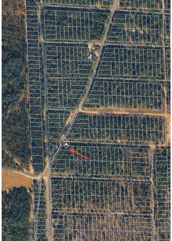 This is an aerial map showing a vacant lot marked with a red arrow — BADEN POWELL ROAD, HAWTHORNE, FL