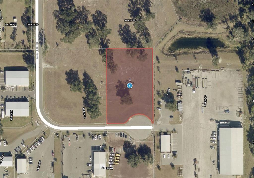 This is an aerial map showing a rectangular parcel of land highlighted in red — 1080 DUCK BOX ROAD, UMATILLA, FL