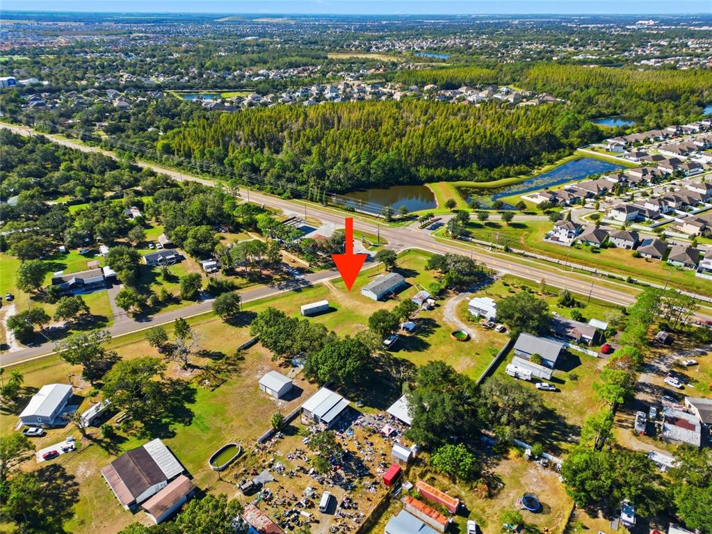 An aerial view shows a residential lot with a small house and scattered debris — 12422 BALM RIVERVIEW ROAD, RIVERVIEW, FL