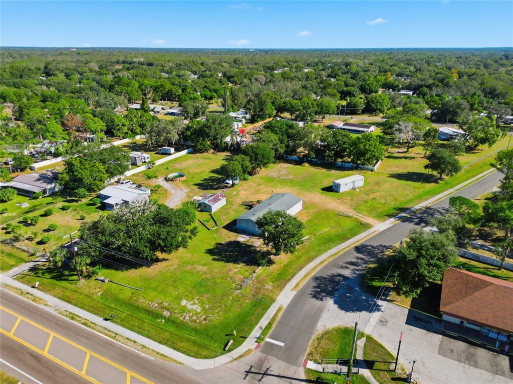 An aerial view shows a residential lot with a house, outbuildings, and surrounding trees — 12422 BALM RIVERVIEW ROAD, RIVERVIEW, FL