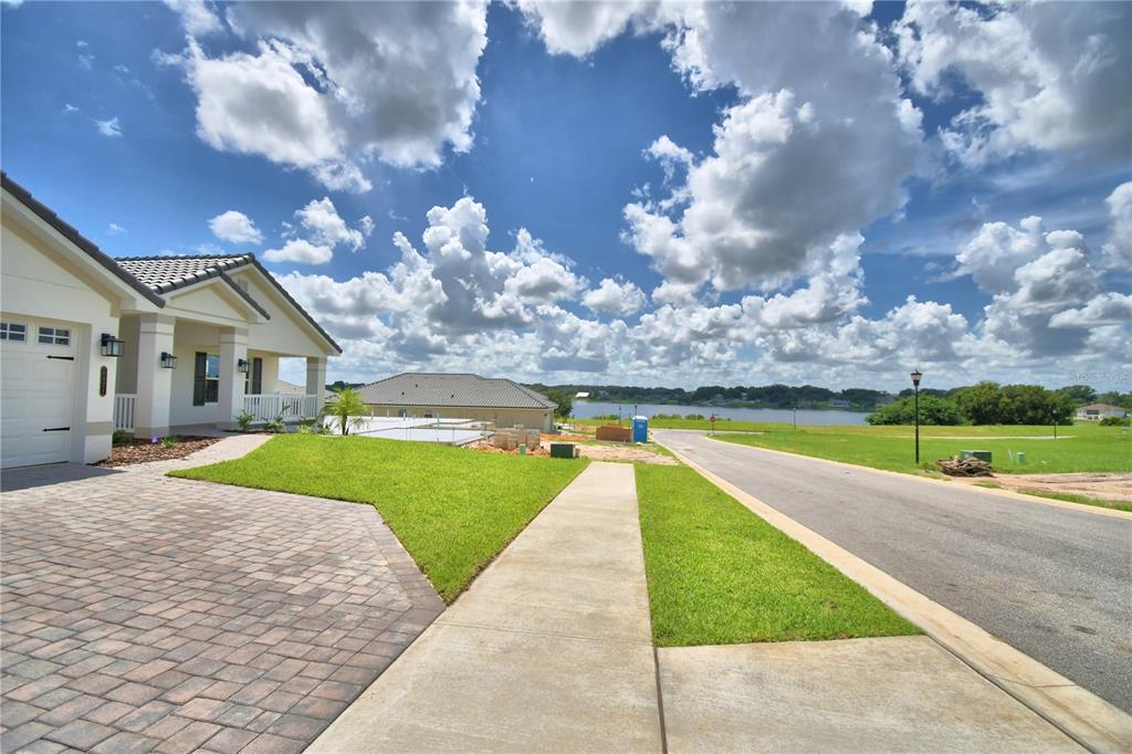 An entryway leads into a dining area featuring wood-look tile flooring and white trim — 5421 WATERSIDE DRIVE, AUBURNDALE, FL