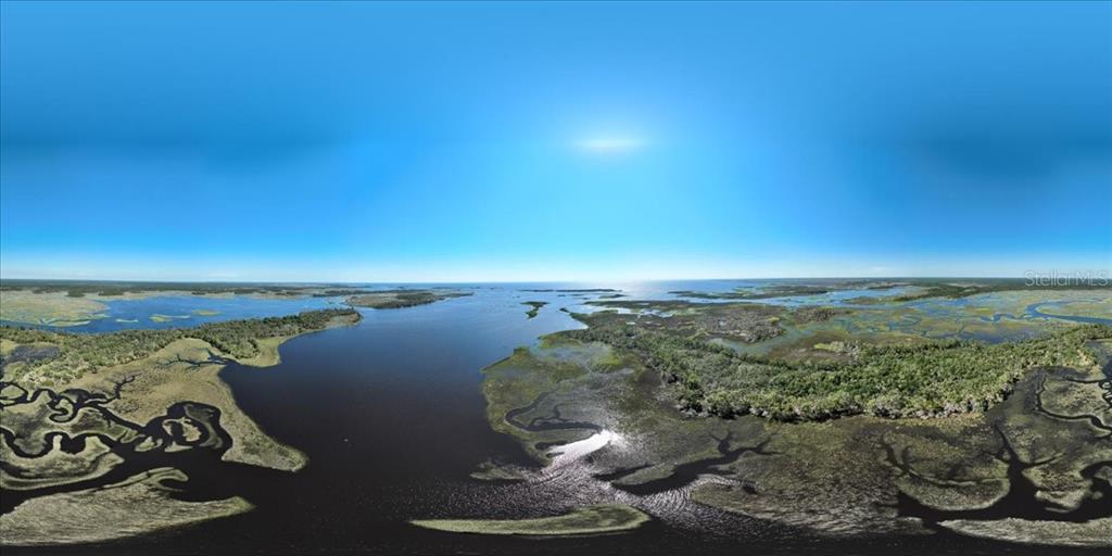 An aerial panoramic view of a coastal marshland with winding waterways and dense vegetation — 00000 CLARK ISLAND, CEDAR KEY, FL
