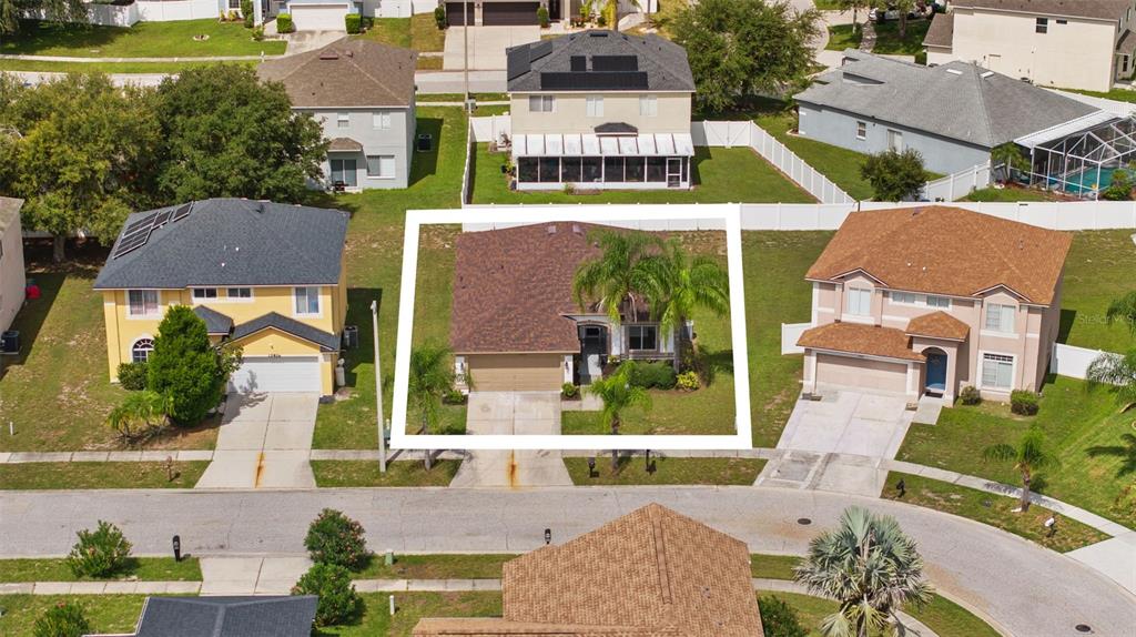 An aerial view shows a single-story house with a brown roof and palm trees — 12826 LONGCREST DRIVE, RIVERVIEW, FL