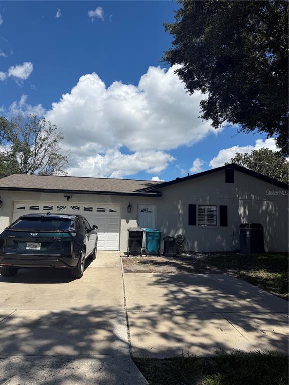An aerial view of a single-story house with a dark roof and a driveway — 1241 ANGELINE AVENUE, ORLANDO, FL