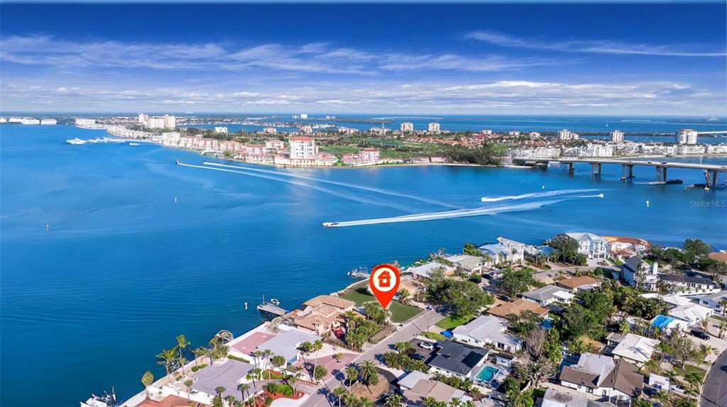 An aerial view shows a waterfront residential property marked with a red location pin — 500 BELLE POINT DRIVE, ST PETE BEACH, FL