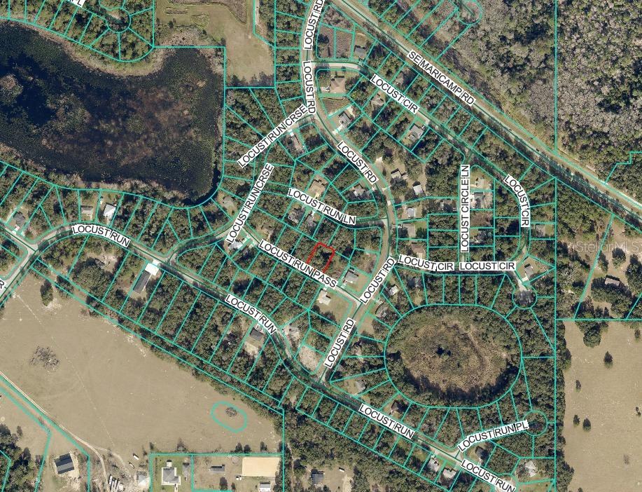 This is an aerial map showing residential streets and property boundaries in a wooded area — LOCUST RUN PASS, OCALA, FL