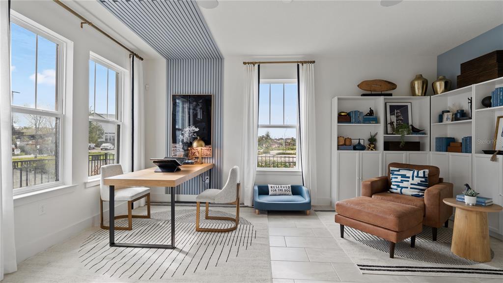 A home office features a wood desk, a blue dog bed, and built-in white bookshelves — 15153 GROVESIDE ROAD, WINTER GARDEN, FL