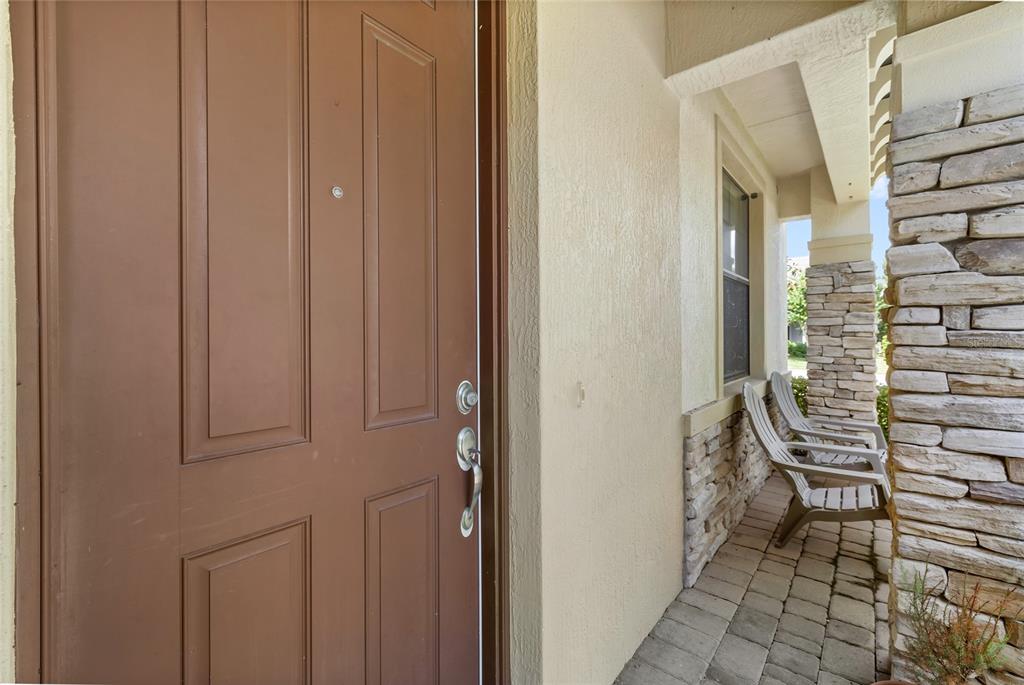 A kitchen with wood cabinets, granite countertops, stainless steel appliances, and a central island — 10155 EAGLE CREEK CENTER BOULEVARD, ORLANDO, FL