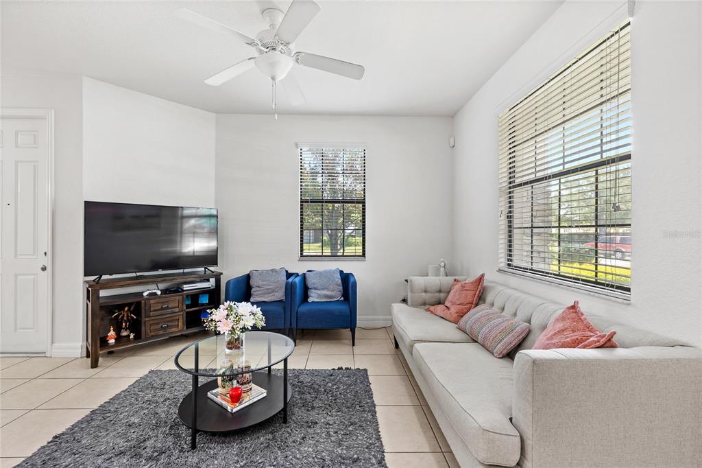 A kitchen with wood cabinets, granite countertops, stainless steel appliances, and a breakfast bar island — 10155 EAGLE CREEK CENTER BOULEVARD, ORLANDO, FL