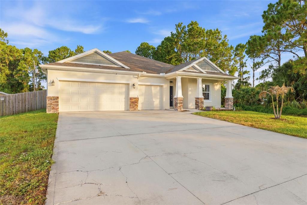 An aerial view shows a single-story house with a fenced backyard and surrounding trees — 242 HERITAGE STREET SW, PALM BAY, FL