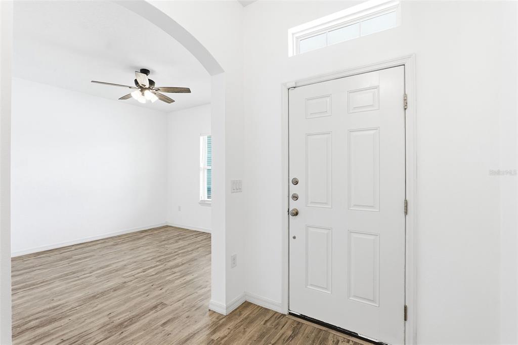 An empty bedroom features white walls, gray carpet, a ceiling fan, and a single window — 242 HERITAGE STREET SW, PALM BAY, FL