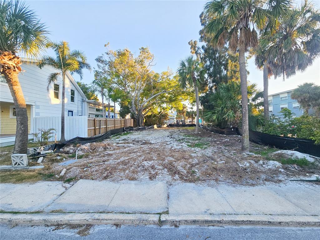 A vacant, cleared residential lot features palm trees and a black silt fence — 110 4TH AVENUE, ST PETE BEACH, FL