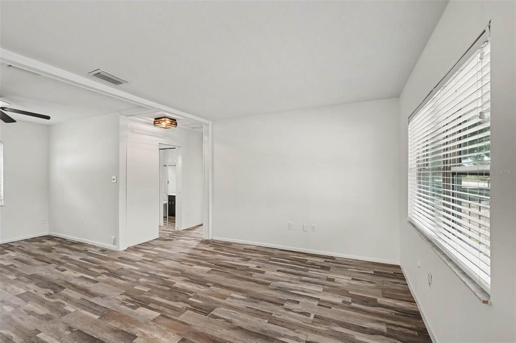 An empty room with white walls, wood-look flooring, a ceiling fan, and window blinds — 313 MILLER MAC ROAD, APOLLO BEACH, FL