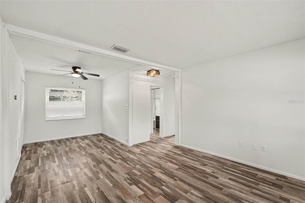 An empty room with white walls, a ceiling fan, and wood-look flooring — 313 MILLER MAC ROAD, APOLLO BEACH, FL