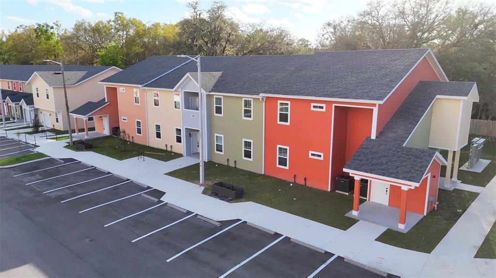 An aerial view of a multi-colored apartment building with an adjacent parking lot — 1581 NW 29TH ROAD UNIT 2, GAINESVILLE, FL