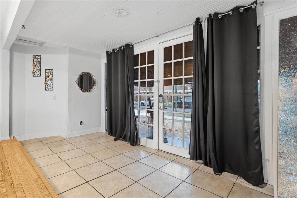 A living room with hardwood floors, a white sofa, and an open kitchen with gray cabinets — 816 E JEFFERSON STREET, ORLANDO, FL