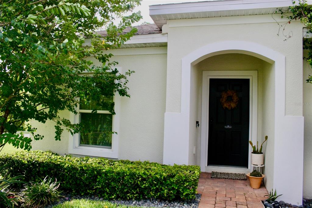 A single-story house with a brick paver driveway, a two-car garage, and a manicured lawn — 5501 SABAL DRIVE, ST CLOUD, FL