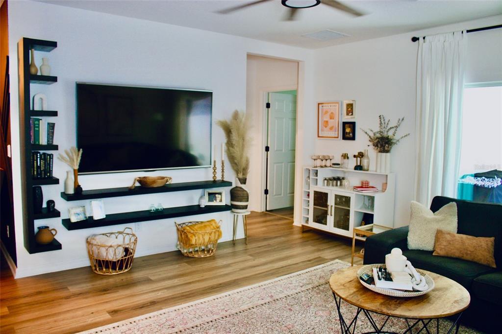 An entryway features a console table, a wooden bench, wall art, and a runner rug — 5501 SABAL DRIVE, ST CLOUD, FL