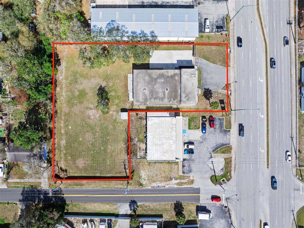 An aerial view shows a commercial property outlined in red with two buildings and parking — 974 S NOVA ROAD, ORMOND BEACH, FL