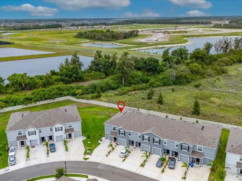 An aerial view shows a community swimming pool, covered patio, and playground next to parking — 416 MANGROVE SHADE CIRCLE, APOLLO BEACH, FL
