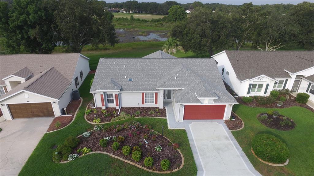 An aerial view of a single-story house with a red garage door and landscaped yard — 4755 TARA VIEW ROAD, LEESBURG, FL