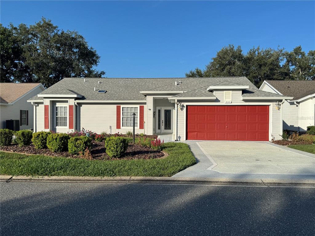 A single-story house with light gray siding, red shutters, and a red two-car garage — 4755 TARA VIEW ROAD, LEESBURG, FL