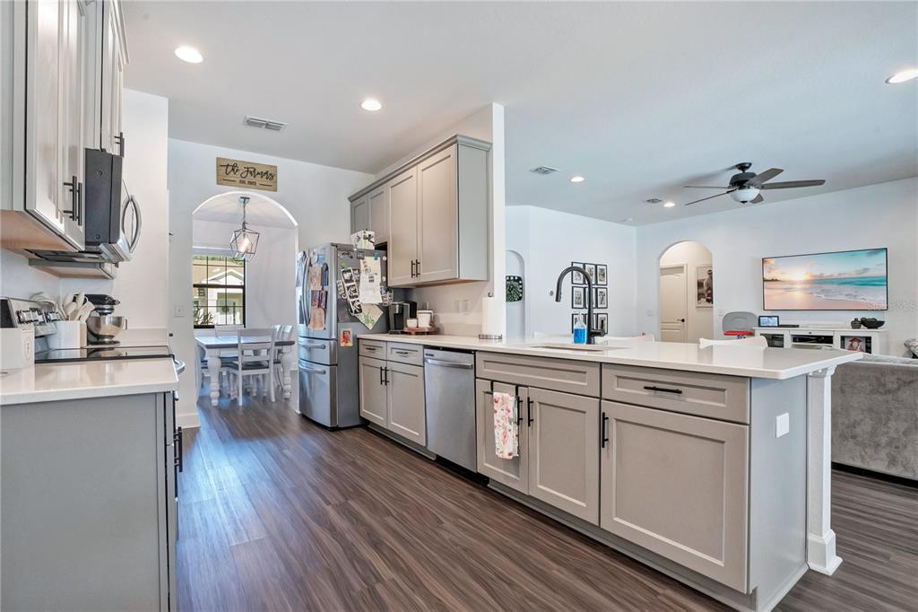 A single-story house with a white stucco exterior, a front porch, and a two-car garage — 525 GANDHI DRIVE, LAKELAND, FL