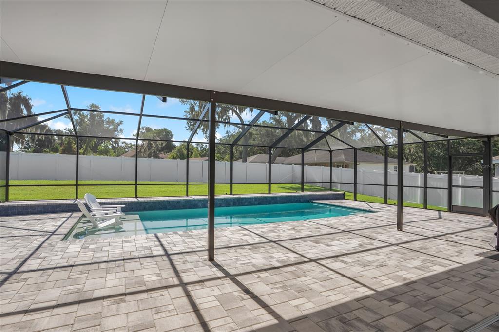 A single-story suburban house with a two-car garage, light-colored stucco exterior, and a shingled roof — 525 GANDHI DRIVE, LAKELAND, FL
